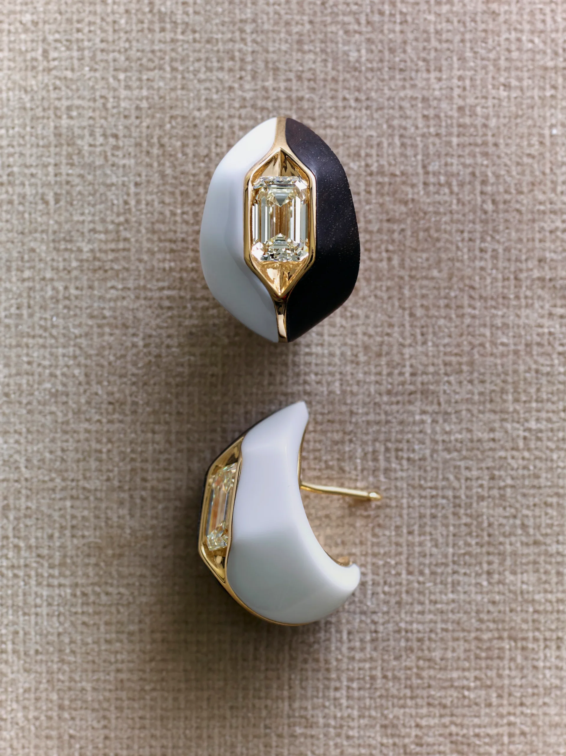 Fernando Jorge’s High Armour earrings in 18-carat yellow gold, set with a 5.15-carat elongated emerald-cut diamond and framed by hand-carved white opal and ebony