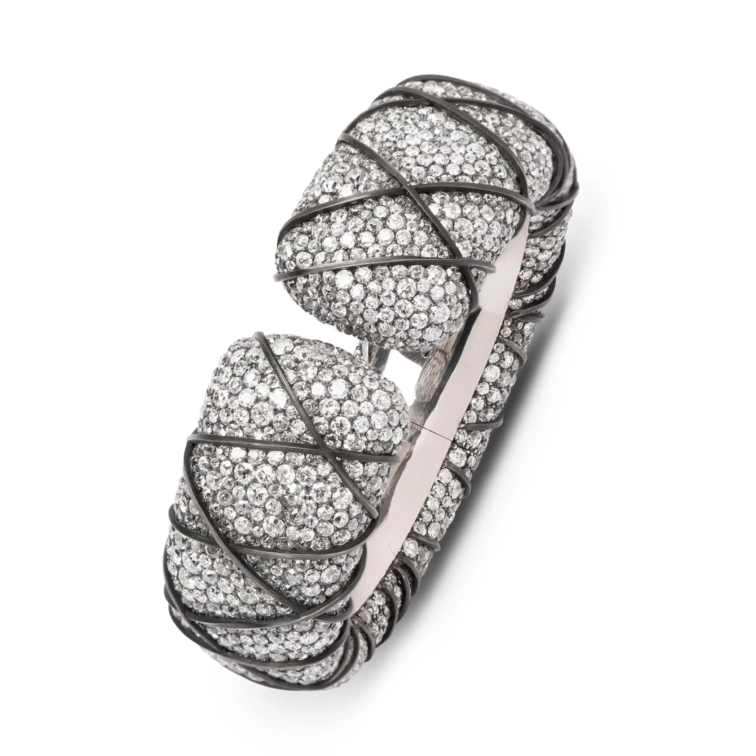 Fine straps of iron wind tightly around the diamond-set bangle